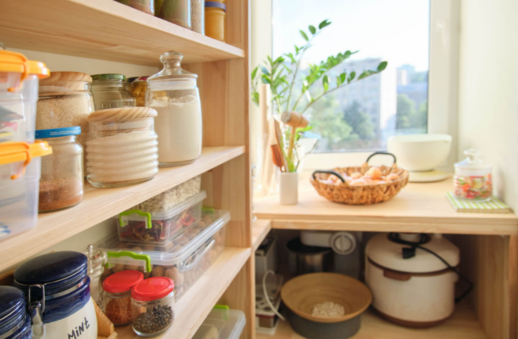 Easy-to-reach kitchen tools and containers of food arranged on wooden shelves.