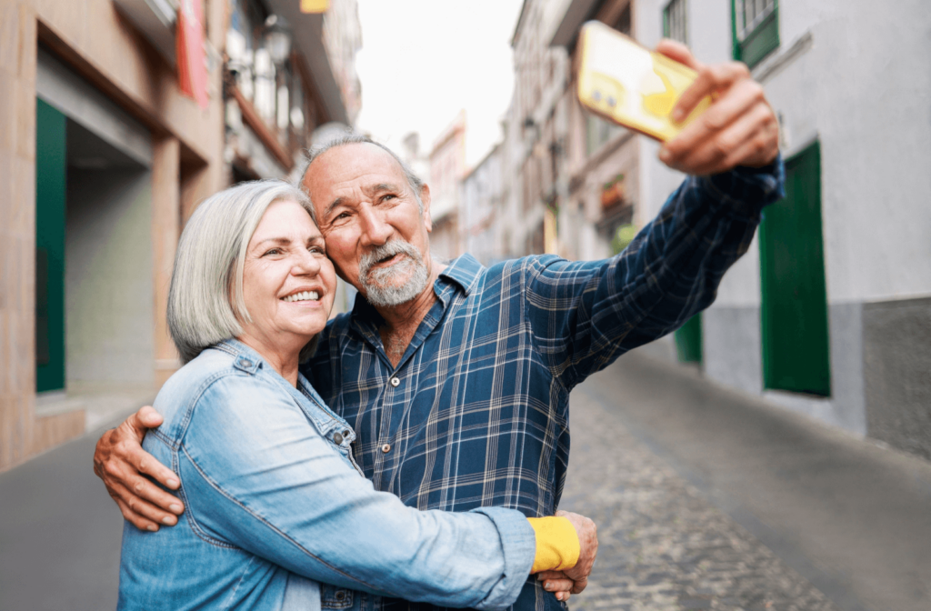 A senior couple stops for a selfie during a European walking tour.