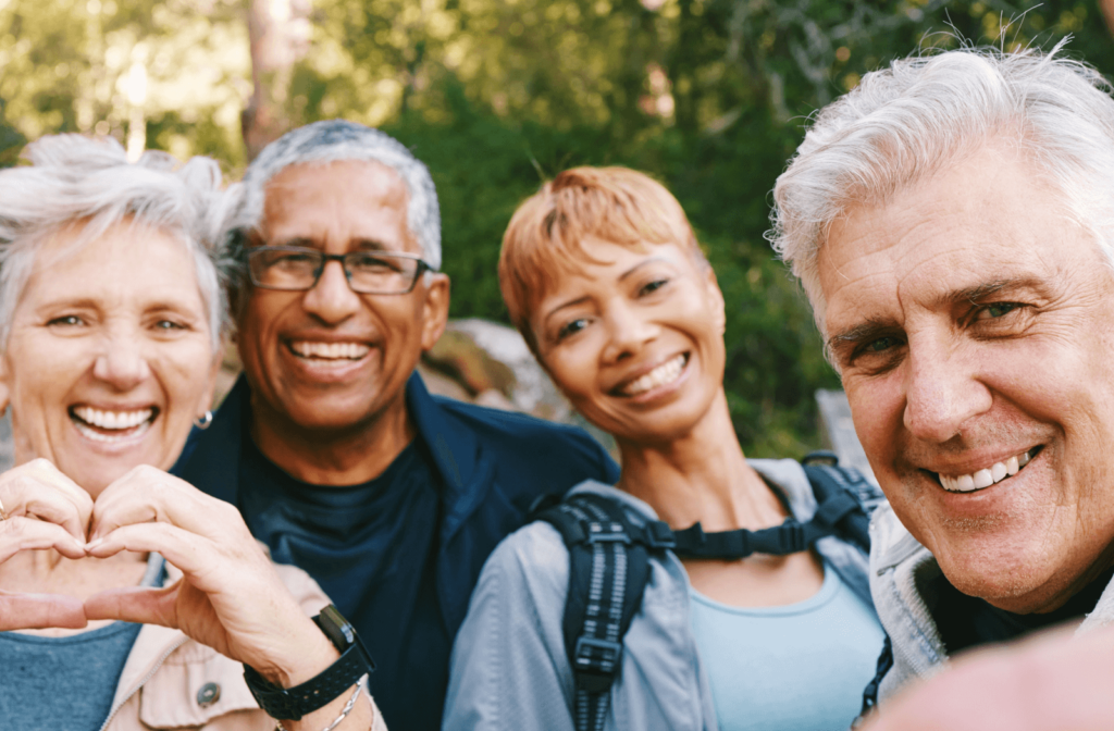 2 senior couples smile for the camera on a holiday excursion.